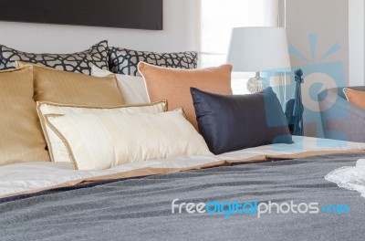 Pillows On Luxury Bed With White Lamp In Bedroom Stock Photo