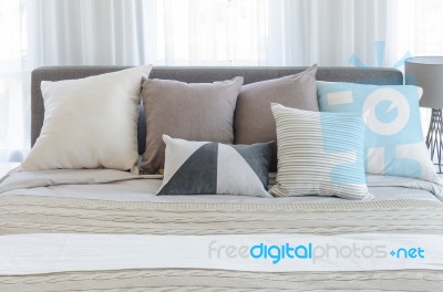 Pillows On Modern Bed In Modern Bedroom Stock Photo