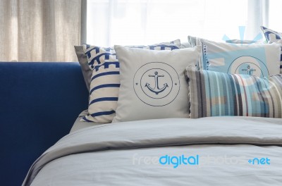 Pillows On Modern Blue Bed In Bedroom Stock Photo