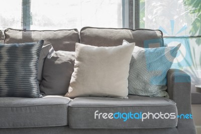 Pillows On Modern Grey Sofa In Living Room Stock Photo