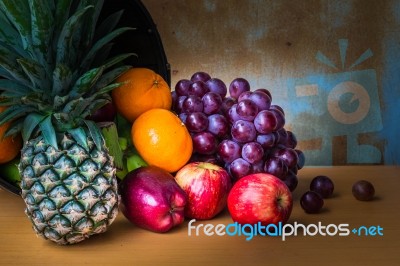 Pineapple And Fruits From On A Wooden Stock Photo