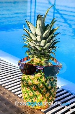 Pineapple Wearing Sunglasses At Swimming Pool Stock Photo