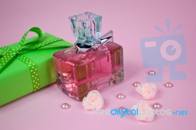 Pink Aromatic Perfume With Green Vintage Gift And Pearls And Roses On Pink Background Stock Photo