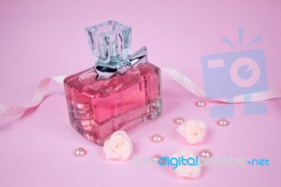 Pink Aromatic Perfume With Pink Pearls And Pink Textile Roses On Pink Background Stock Photo