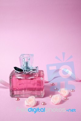 Pink Aromatic Perfume With Pink Pearls And Pink Textile Roses On Pink Background Stock Photo