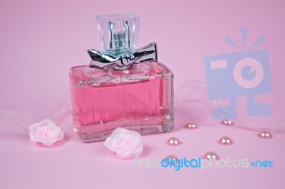 Pink Aromatic Perfume With Pink Pearls And Pink Textile Roses On Pink Background Stock Photo