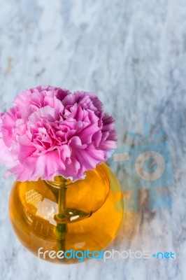 Pink Artificial Flower In Brown Round Bottle Stock Photo