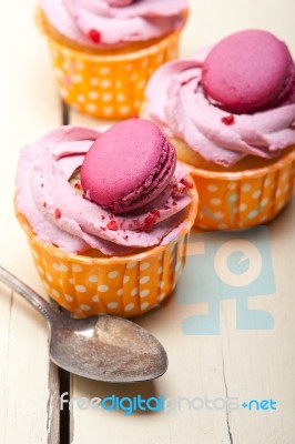 Pink Berry Cream Cupcake With Macaroon On Top Stock Photo