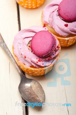 Pink Berry Cream Cupcake With Macaroon On Top Stock Photo
