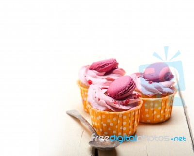 Pink Berry Cream Cupcake With Macaroon On Top Stock Photo