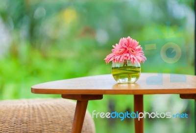 Pink Flowers In Vase On Table In The Garden Stock Photo