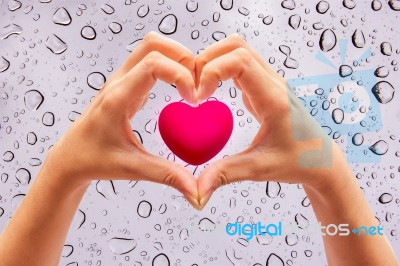 Pink Heart In Hands On Nature Background Stock Photo