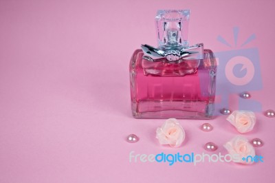 Pink Perfume With Pink Pearls And Pink Textile Roses On Pink Background Stock Photo