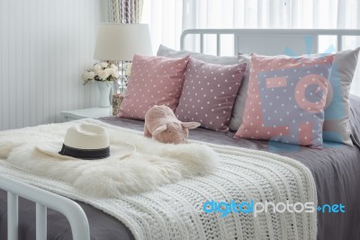 Pink Pillows With Pink Doll On White Wooden Bed And Classic Hat Stock Photo