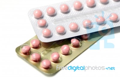 Pink Pills In Silver And Gold Strips Stock Photo