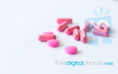 Pink Pills On White Stock Photo