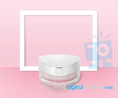 Pink Triangle Cosmetic Jar On Paper Frame Background Stock Photo
