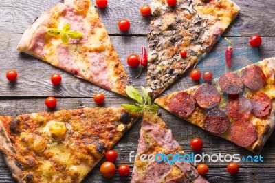 Pizza Cuts On Wooden Table Stock Photo