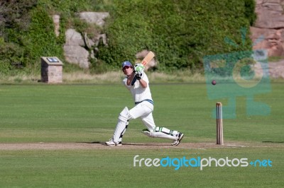 Playing Cricket On The Green At Bamburgh Stock Photo