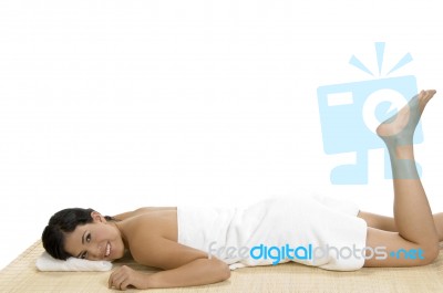 Pleased Woman Laying On Bamboo Mat Stock Photo
