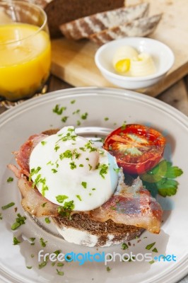 Poached Egg And Bacon On Rye Bread, Healthy Breakfast Stock Photo