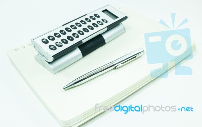 Pocket Calculator And Pen On The Table Stock Photo
