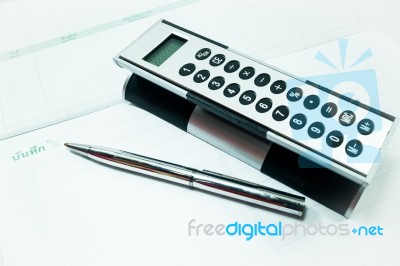 Pocket Calculator And Pen On The Table Stock Photo