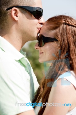 Portrait Of A Beautiful Couple Hugging Stock Photo