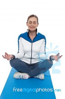 Portrait Of A Woman Sitting In A Lotus Position Stock Photo
