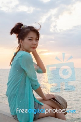 Portrait Of Asian Woman Relaxing Vacation Holiday At Sea Side With Sun Set Sky Background Stock Photo