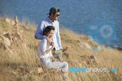 Portrait Of Asian Younger Man And Woman Relaxing Vacation At Sea Side Happiness Emotion Stock Photo