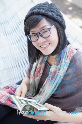 Portrait Of Beautiful Asian Woman Relaxing Time Reading Book On Cradle Happiness Emoton With Smiling Face Stock Photo