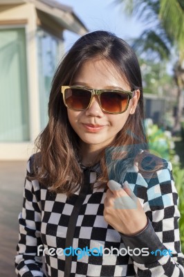 Portrait Of Beautiful Chick Fashion Woman Wearing Sun Glasses Against Afternoon Light With Blur Background And Copy Space Stock Photo