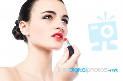 Portrait Of Beautiful Girl Applying Lipstick Stock Photo