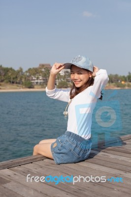 Portrait Of Beautiful Woman Happy Face Sitting On Wood Port Sea Stock Photo