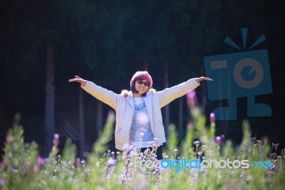 Portrait Of Happiness Asian Woman With Smiling Face In Blooming Flowers Garden Use For Relaxing People In Vacation Traveling Stock Photo