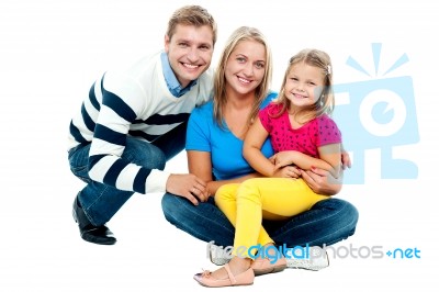 Portrait Of Happy Couple Smiling With Cute Daughter Stock Photo