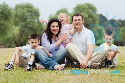 Portrait Of Happy Family Of Five On The Green Land Stock Photo