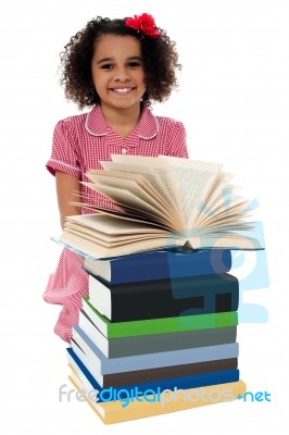 Portrait Of Pretty Schoolgirl Reading Textbook Stock Photo