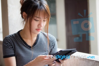 Portrait Of Thai Adult Beautiful Girl Using Her Tablet Stock Photo