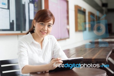 Portrait Of Thai Adult Businesswoman Beautiful Girl Using Her Tablet Stock Photo