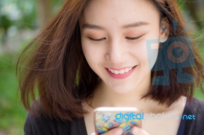Portrait Of Thai Adult Student University Beautiful Girl Using Her Smart Phone Stock Photo