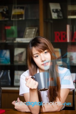 Portrait Of Thai Adult Student University Uniform Beautiful Drinking Coffee Stock Photo