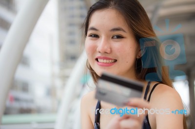 Portrait Of Thai Chinese Adult Beautiful Girl Denim Blue Bag Credit Card Stock Photo