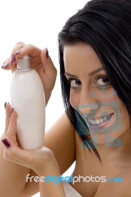 Portrait Of Woman With Lotion Bottle Stock Photo
