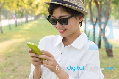 Portrait Of Young Beautiful Asian Woman And Smart Phone In Hand Smiling Toothy Face Connecting Mobile Phone In Hand Use For People Modern Life Style In Digital Trend Stock Photo
