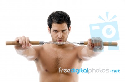 Portrait Of Young Man With Nunchaku Stock Photo