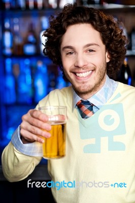 Positive Young Man Holding A Glass Of Beer Stock Photo