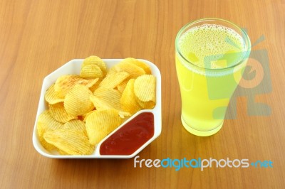 Potato Chip And Beverage On Table Stock Photo
