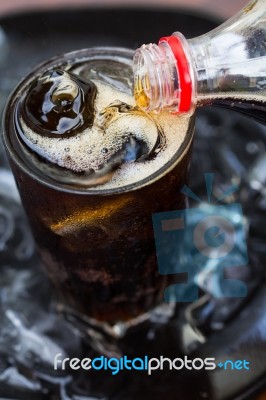Pouring Cola Into Glass Stock Photo